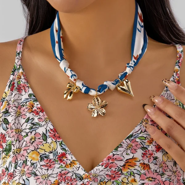 عقد نسائي بتعليقة على شكل كرز وفراولة وقلب مع فيونكة، مزين بشريط ملوّن